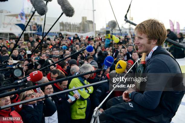 French skipper Francois Gabart celebrates on his boat after winning the 7th edition of the Vendee Globe solo round-the-world race on January 27, 2013...