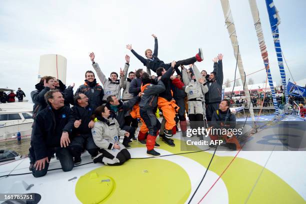 French skipper Francois Gabart celebrates on his boat after winning the 7th edition of the Vendee Globe solo round-the-world race on January 27, 2013...