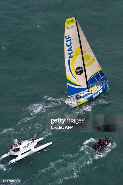 French skipper Francois Gabart arrives aboard his boat "Macif" after winning the 7th edition of the Vendee Globe solo round-the-world race on January...