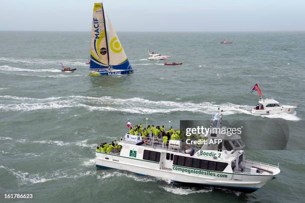 French skipper Francois Gabart arrives aboard his boat "Macif" after winning the 7th edition of the Vendee Globe solo round-the-world race on January...