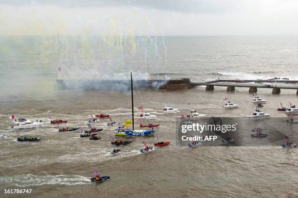 French skipper Francois Gabart arrives aboard his boat "Macif" after winning the 7th edition of the Vendee Globe solo round-the-world race on January...