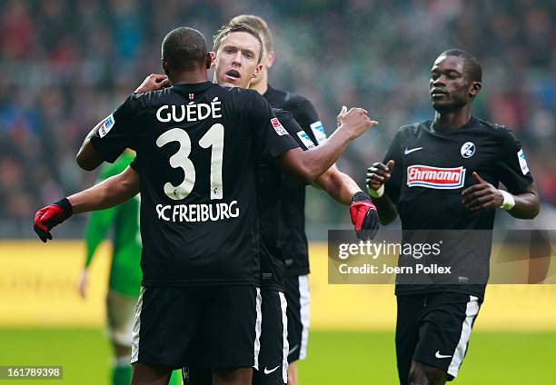 Max Kruse of Freiburg celebrates with his team mates after scoring his team's first goal during the Bundesliga match between SV Werder Bremen and SC...