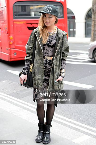 Julliette poses wearing an outfit from River Island with a hat and jewellery from a Polish market with a Moschino bag at Somerset House during London...