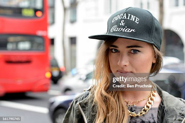 Julliette poses wearing an outfit from River Island with a hat and jewellery from a Polish market with a Moschino bag at Somerset House during London...