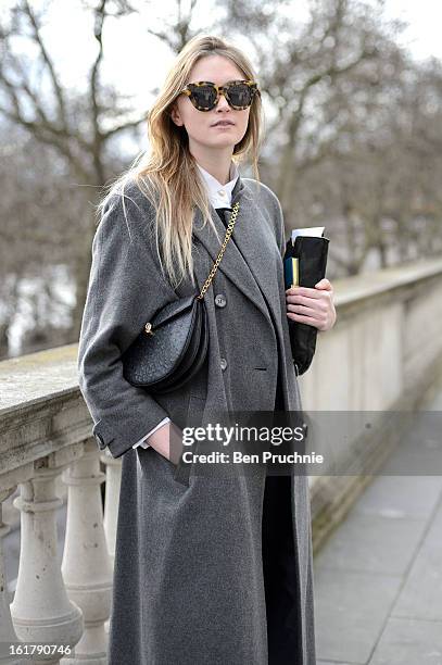 Fashion journalist Jane poses wearing a Topshop jumpsuit, Marks and Spencer shirt, Vintage coat and bag with Hudson shoes at Somerset House during...