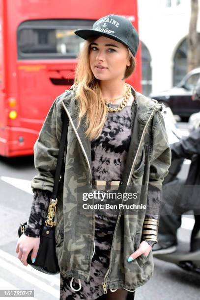 Julliette poses wearing an outfit from River Island with a hat and jewellery from a Polish market with a Moschino bag at Somerset House during London...