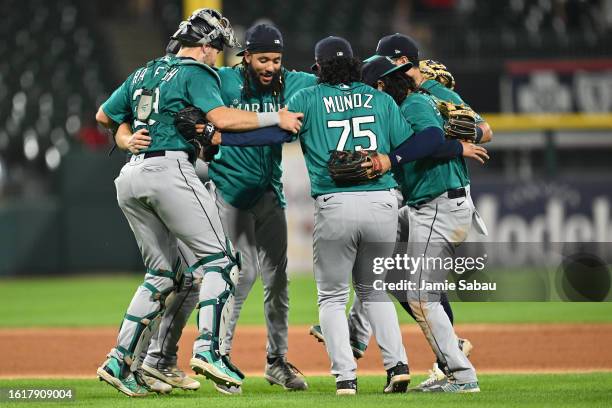 Crawford of the Seattle Mariners, Cal Raleigh and Andres Munoz celebrate after defeating the Chicago White Sox 6-3 at Guaranteed Rate Field on August...