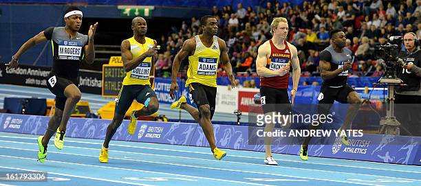 Michael Rodgers of the US wins the mens 60 metres Final, Nesta Carter of Jamaica second, Antoine Adams of Saint Kitts and Nevis , third, Kim Collins...