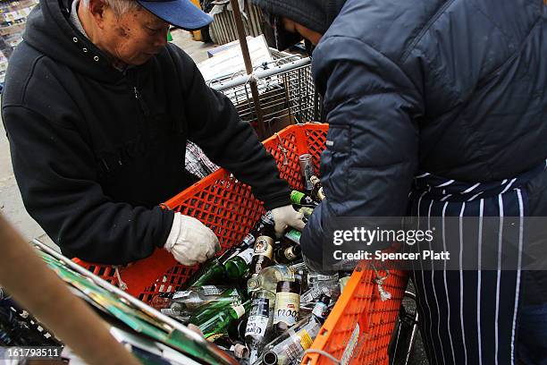 Couple who make their living by collecting bottles and cans or "canning" for short, sort through an evenings collection at Sure We Can, a non-profit...