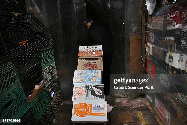 Man who makes a living by collecting bottles and cans or "canning" for short, moves an evenings collection to be counted and sorted at Sure We Can, a...