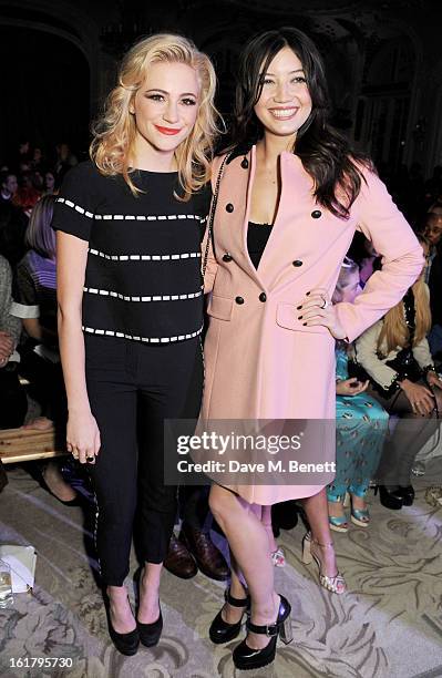 Pixie Lott and Daisy Lowe attend the Moschino cheap&chic show during London Fashion Week Fall/Winter 2013/14 at The Savoy Hotel on February 16, 2013...