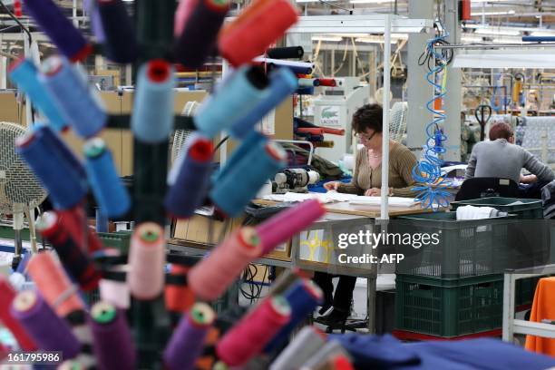 Employees work at a plant of French apparel company Lacoste, on January 7, 2013 in Troyes. Lacoste polo shirt is celebrating its 80th birthday in...