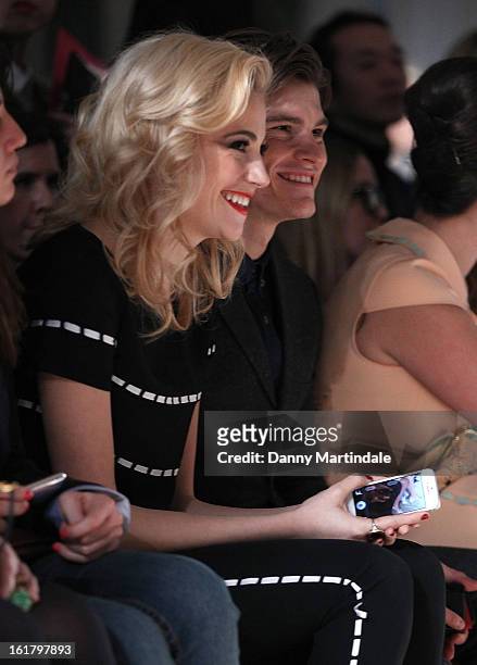 Pixie Lott and Oliver Cheshire watch the Moschino cheap&chic show during London Fashion Week Fall/Winter 2013/14 at The Savoy Hotel on February 16,...