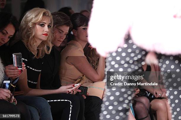 Pixie Lott and Oliver Cheshire watch the Moschino cheap&chic show during London Fashion Week Fall/Winter 2013/14 at The Savoy Hotel on February 16,...