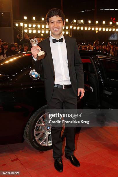 Aziz Zhambakiyev holds the Silver Bear for an outstanding artistic achievement at the Closing Ceremony Red Carpet Arrivals - BMW At The 63rd...