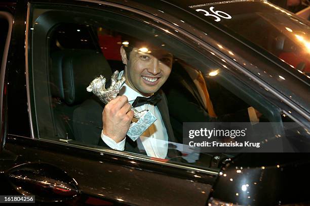 Aziz Zhambakiyev holds the Silver Bear for an outstanding artistic achievement at the Closing Ceremony Red Carpet Arrivals - BMW At The 63rd...