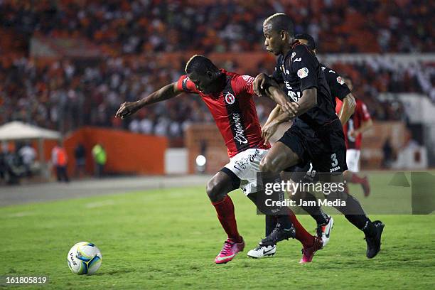 Jhon Cordoba of Jaguares struggles for the ball with Duvier Riascos of Tijuana during the Clausura 2013 Liga MX at Victor Manuel Reyna Stadium on...