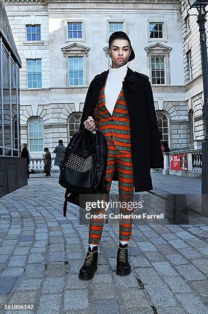 Joel Jay-P Stylist and Model wearing Dent de Man suit, white Uniglo turtle necked top, Top Man cap, Toppu Japanese bag, and original Doc Martinsat...