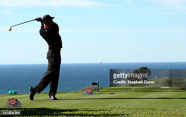 Tiger Woods hits his tee shot on the 17th hole during the final round of the Farmers Insurance Open on the South Course at Torrey Pines Golf Course...