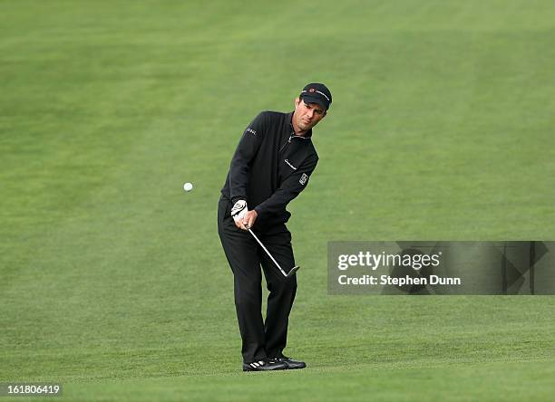 Mike Weir of Canada chips on the second hole during the final round of the Farmers Insurance Open on the South Course at Torrey Pines Golf Course on...