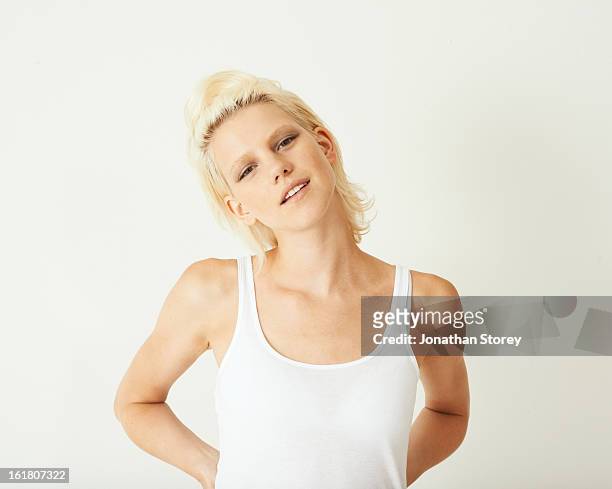 portrait for blond female with hands on hips - young blonde woman facing away stock-fotos und bilder