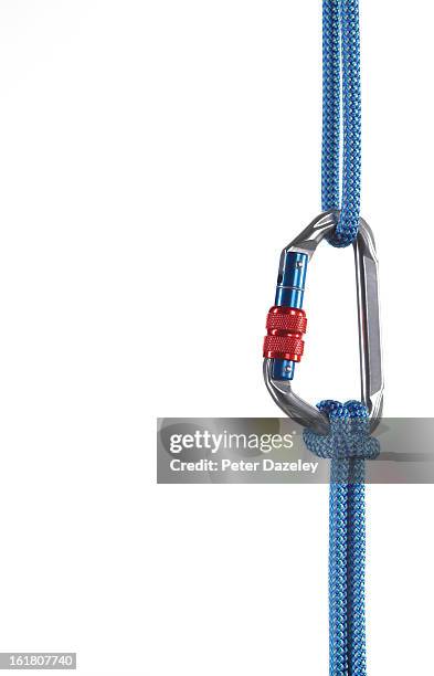 karabiner hanging on white background - equipamento de alpinismo imagens e fotografias de stock