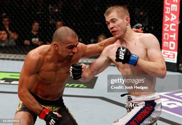 Michael McDonald punches Renan Barao in their interim bantamweight title fight during the UFC on Fuel TV event on February 16, 2013 at Wembley Arena...