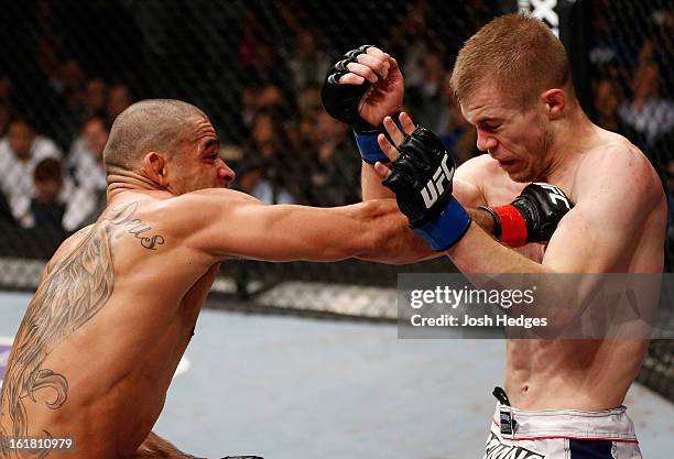 Renan Barao punches Michael McDonald in their interim bantamweight title fight during the UFC on Fuel TV event on February 16, 2013 at Wembley Arena...