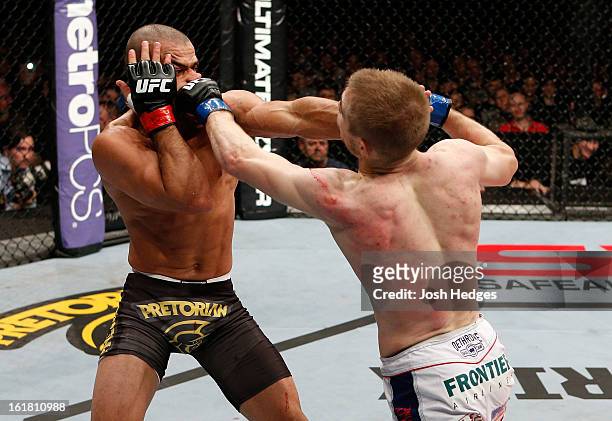 Michael McDonald and Renan Barao trade punches in their interim bantamweight title fight during the UFC on Fuel TV event on February 16, 2013 at...