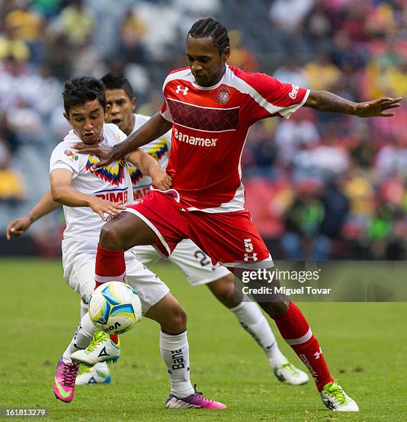 February 16: Christian Bermudez of America fights for the ball with Wilson Tiago of Toluca during a Clausura 2013 Liga MX match between America and...