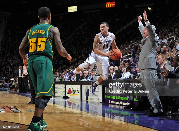 Guard Angel Rodriguez of the Kansas State Wildcats saves the ball from going out of bounds, as guard Pierre Jackson of the Baylor Bears looks on...