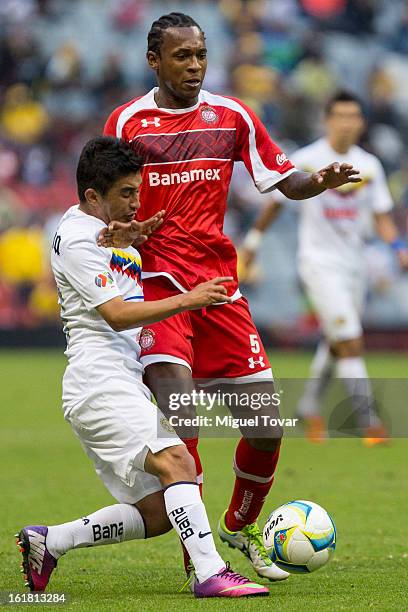 February 16: Christian Bermudez of America fights for the ball with Wilson Tiago of Toluca during a Clausura 2013 Liga MX match between America and...