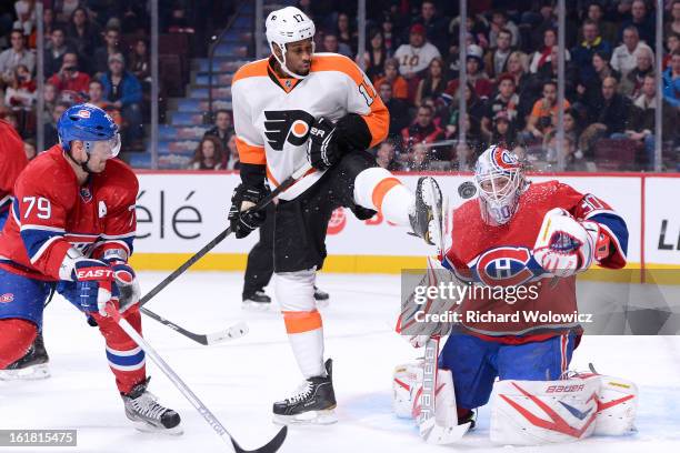 Wayne Simmonds of the Philadelphia Flyers attempts to screen on Peter Budaj of the Montreal Canadiens during the NHL game at the Bell Centre on...
