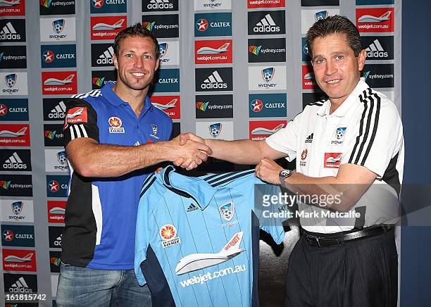 New signing Lucas Neill is presented with a Sydney FC jersey by Coach Frank Farina during a Sydney FC press conference at Macquarie Uni on February...