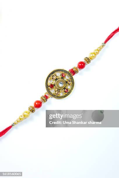 rakhi on a white background. - akhi stock pictures, royalty-free photos & images