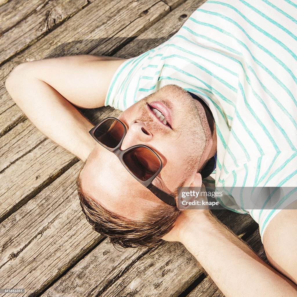 Man relaxing outdoors in sun