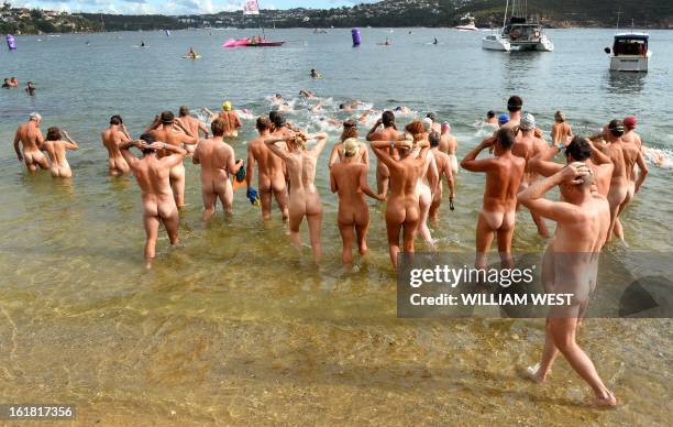 The first wave of nude swimmers enter the surf in the "Sydney Skinny" - in what is dubbed the first mass nude ocean swim in Sydney on February 17,...