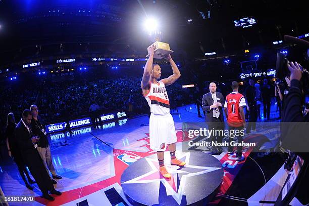 Damian Lillard of the Portland Trail Blazers is presented the during 2013 Taco Bell Skills Challenge trophy on State Farm All-Star Saturday Night as...