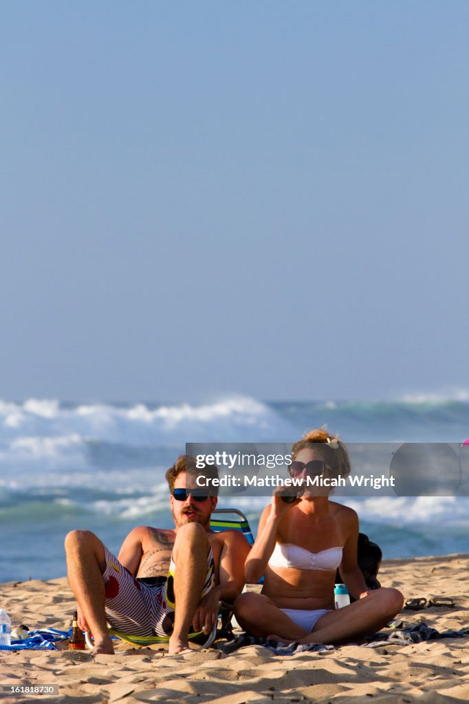 A couple relaxes on the beach