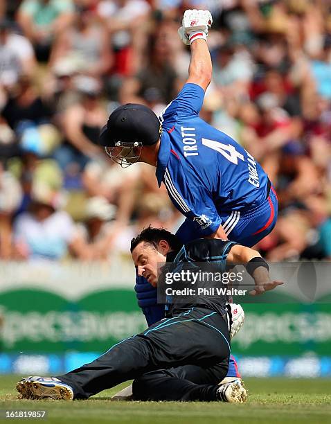 Nathan McCullum of New Zealand collides with Jonathan Trott of England during the first match of the one day international series between New Zealand...