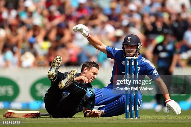 Nathan McCullum of New Zealand collides with Jonathan Trott of England during the first match of the one day international series between New Zealand...