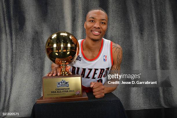 Damian Lillard of the Portland Blazers poses for a portrait with the 2013 Taco Bell Skills Challenge Trophy on State Farm All-Star Saturday Night as...