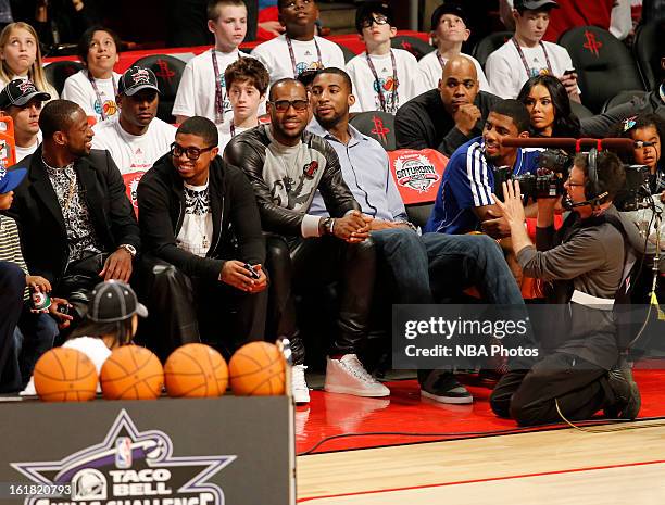 LeBron James of the Miami Heat sits courtside during the Sears Shooting Stars on State Farm All-Star Saturday Night during NBA All Star Weekend on...