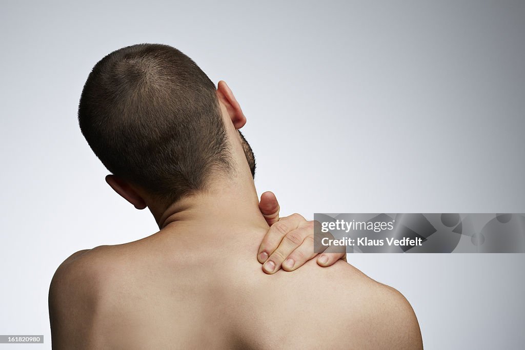 Man grabbing shoulder because of pain