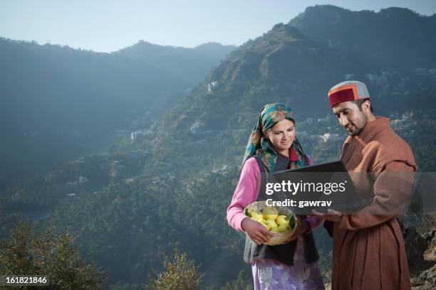 people of himachal pradesh: young women and man using laptop. - himachal pradesh apple stock pictures, royalty-free photos & images