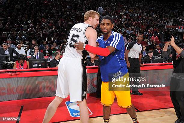 Kyrie Irving of the Cleveland Cavaliers and Matt Bonner of the San Antonio Spurs hug during the 2013 Foot Locker Three-Point Contest on State Farm...