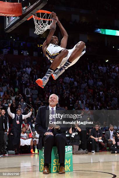 Jeremy Evans of the Utah Jazz dunks the ball over former Jazz player Mark Eaton in the first round during the Sprite Slam Dunk Contest part of 2013...