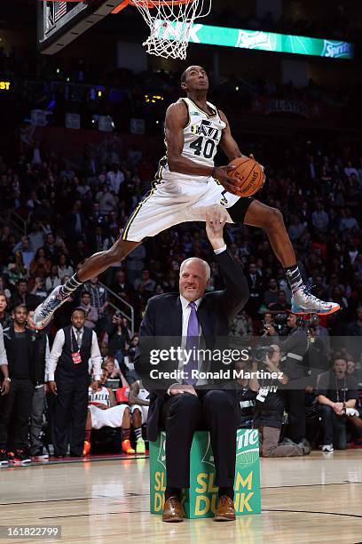 Jeremy Evans of the Utah Jazz dunks the ball over former Jazz player Mark Eaton in the first round during the Sprite Slam Dunk Contest part of 2013...