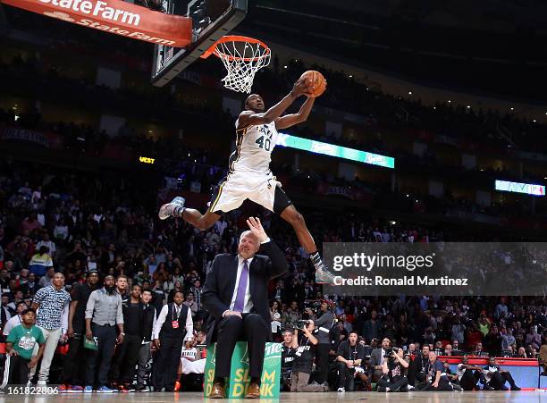 Jeremy Evans of the Utah Jazz dunks the ball over former Jazz player Mark Eaton in the first round during the Sprite Slam Dunk Contest part of 2013...