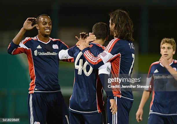 Marko Jesic of the New England Revolution is congratulated by teammates Juan Toja and Bilal Duckett after scoring a goal against the New York Red...